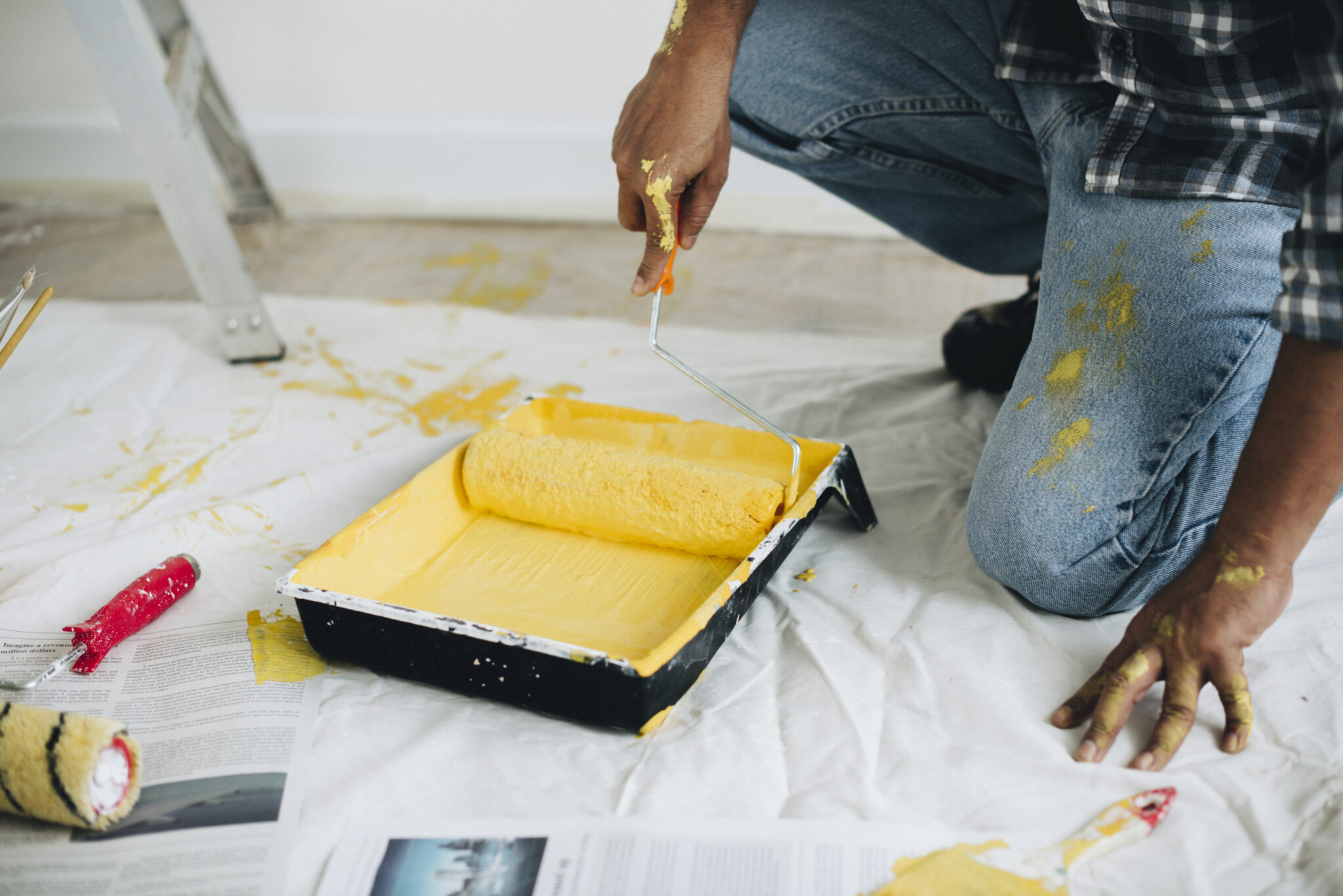 Man painting the walls yellow